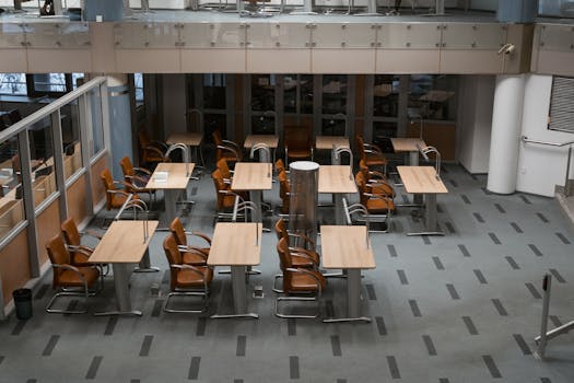 Bright, modern office interior with arranged chairs and tables, ideal for workspaces.
